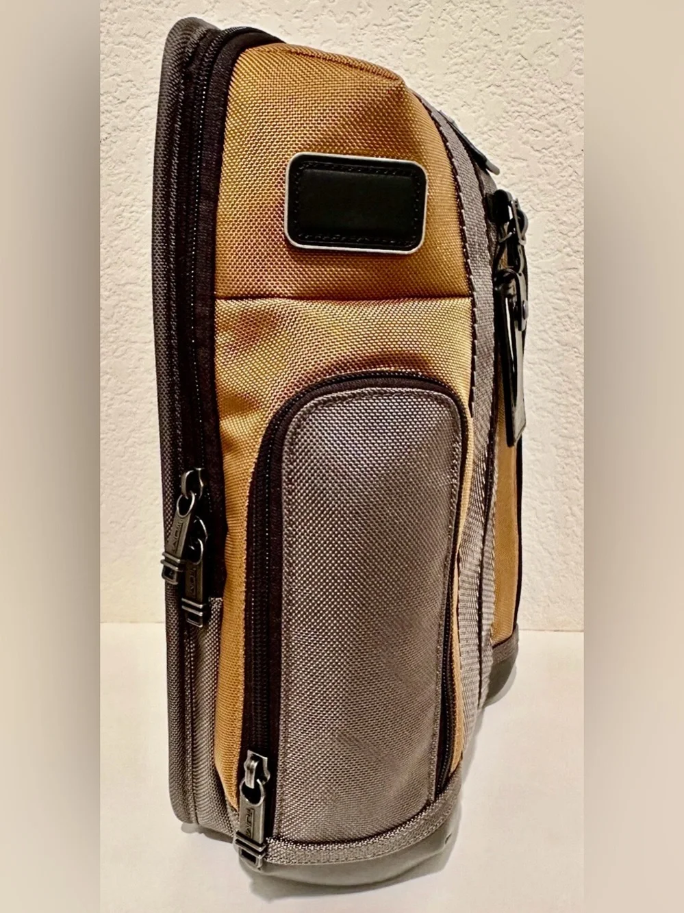 Brand New with Tag TUMI Higgins Sling Golden Brown Gray